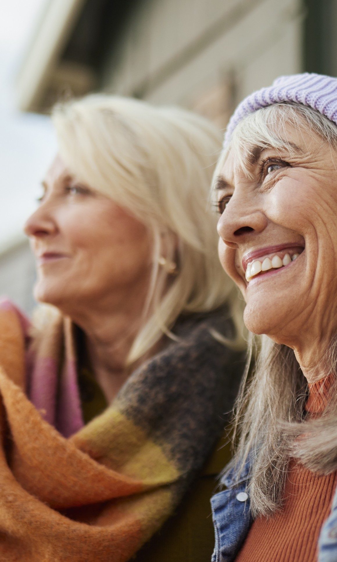 Two smiling women enjoying time together outdoors